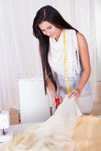 Beautiful woman cutting fabric Stock photo © AndreyPopov