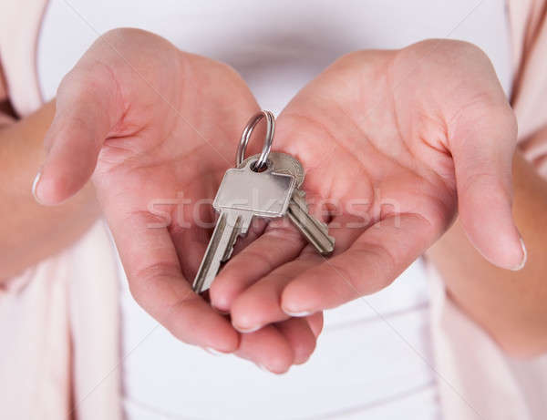 Stock photo: Smiling woman with a set of keys