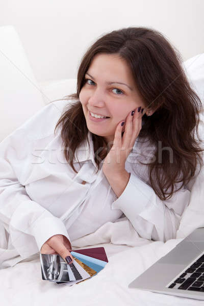 Woman contemplating her credit cards Stock photo © AndreyPopov