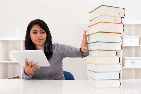 Woman Avoiding Books And Using Tablet Stock photo © AndreyPopov