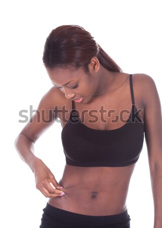 Young African American woman checking tummy fat Stock photo © AndreyPopov