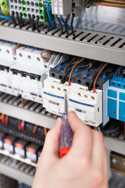Electrician Examining Fusebox With Screwdriver Stock photo © AndreyPopov