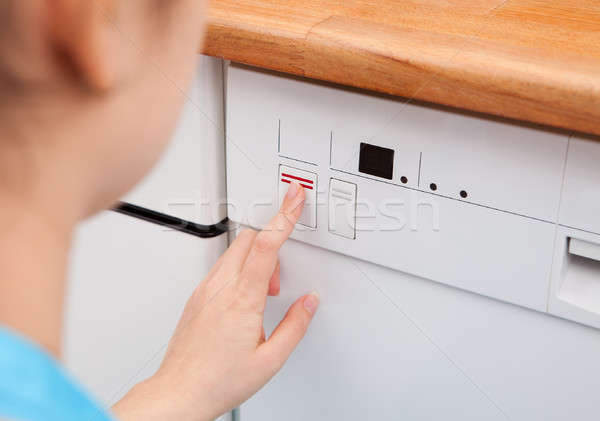 Woman Pressing Button Of Dishwasher Stock photo © AndreyPopov