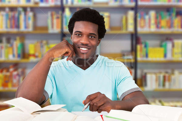 Male University Student Studying In Library Stock photo © AndreyPopov