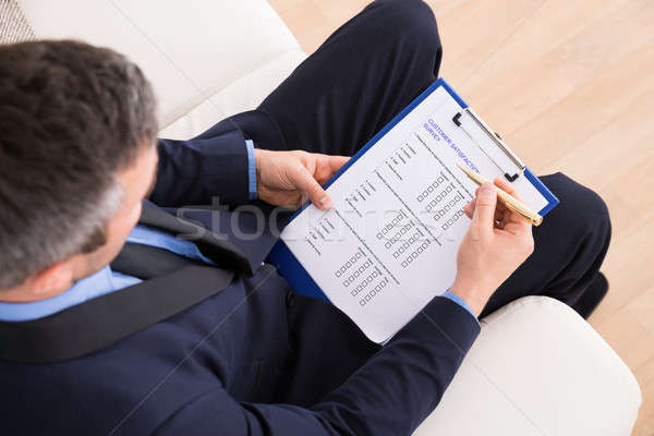 Businessman Filling Customer Survey Form Stock photo © AndreyPopov