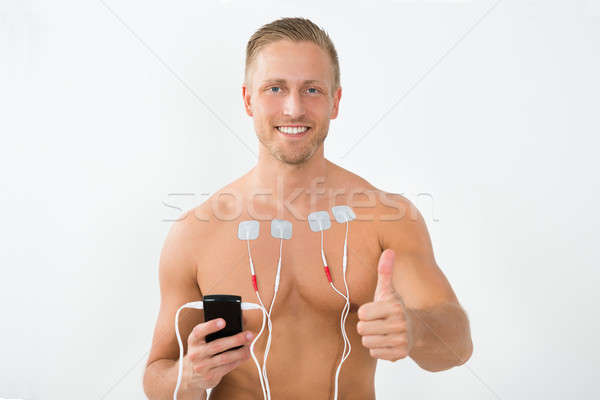 Man With Electrodes Showing Thumbs Up Stock photo © AndreyPopov