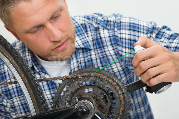 Man Oiling Bicycle Chain Stock photo © AndreyPopov