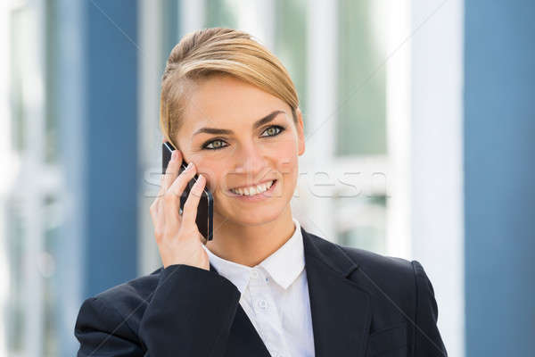 Businesswoman Using Cell Phone Outdoors Stock photo © AndreyPopov