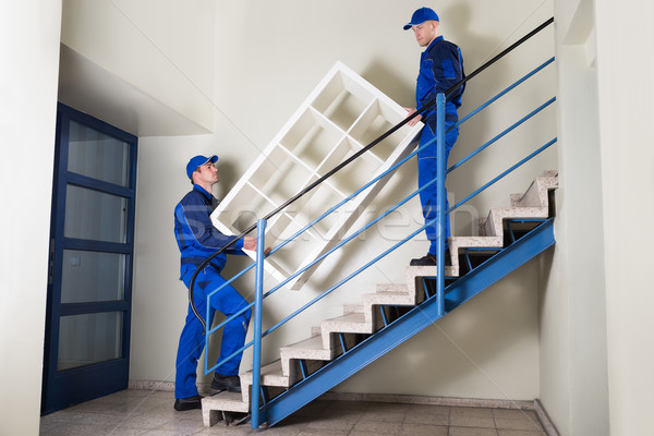 Movers Carrying Shelf While Climbing Steps Stock photo © AndreyPopov