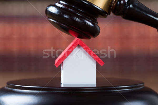 Mallet With House Model On Table In Courtroom Stock photo © AndreyPopov