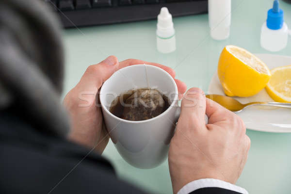 Businessman Holding Cup Of Tea At Office Stock photo © AndreyPopov
