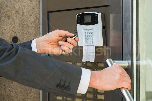 Businessperson Hand Operating Security System Stock photo © AndreyPopov