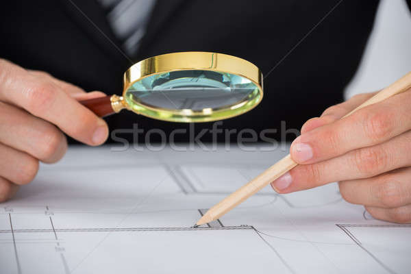 Architect Hand Using Magnifying Glass On Blueprint Stock photo © AndreyPopov