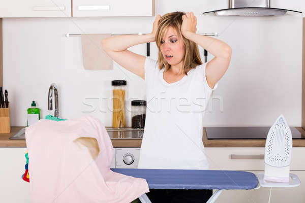 Shocked Woman Looking At Burnt T-shirt Stock photo © AndreyPopov