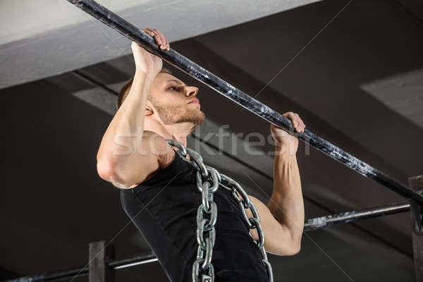 Man Doing Pull-ups On Horizontal Bar Stock photo © AndreyPopov