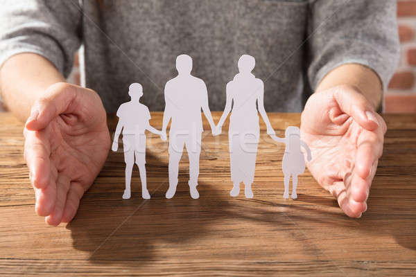 Woman Protecting Family Of White Paper Cut Out Stock photo © AndreyPopov
