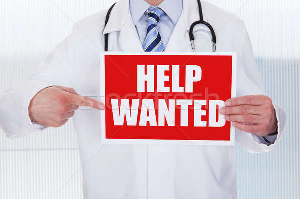 Doctor Holding Help Wanted Banner Stock photo © AndreyPopov