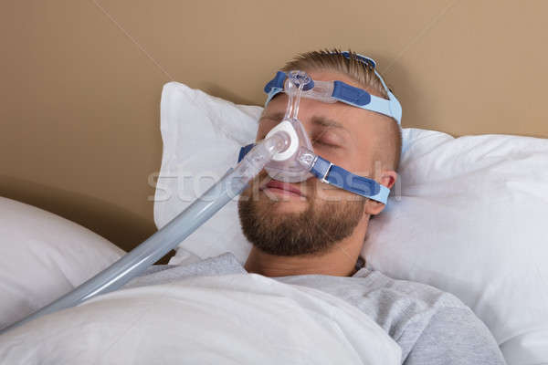 Man With Sleeping Apnea And CPAP Machine Stock photo © AndreyPopov