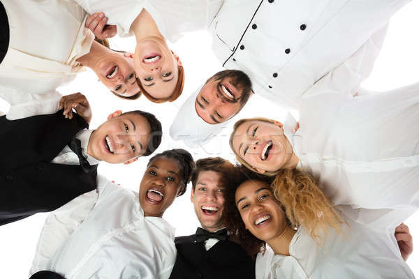 Smiling Restaurant Staff Standing Against White Background Stock photo © AndreyPopov