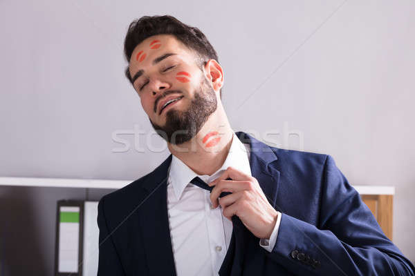 Businessman With Lipstick Kiss Marks On Face Stock photo © AndreyPopov