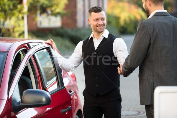 Stock photo: Smiling Valet And Businessperson Standing Near Car