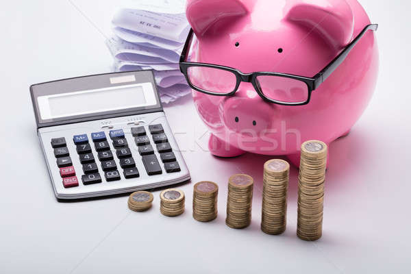 Foto stock: Moedas · piggy · bank · calculadora · secretária