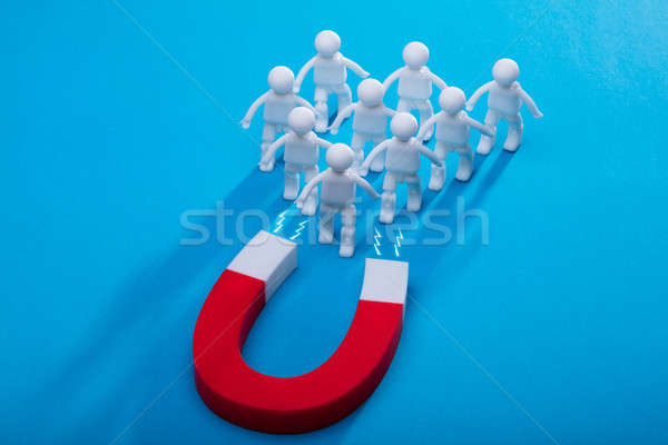 Elevated View Of Horseshoe Magnet Attracting Human Figures Stock photo © AndreyPopov