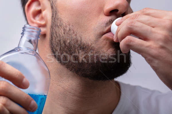 Man Rinsing His Mouth With Mouthwash Stock photo © AndreyPopov
