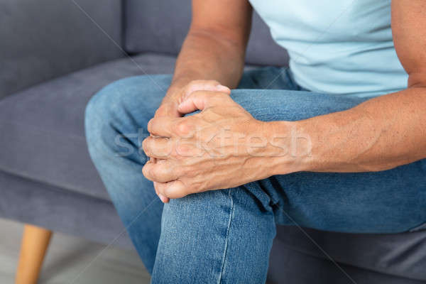 Uomo ginocchio dolore primo piano jeans muscolare Foto d'archivio © AndreyPopov