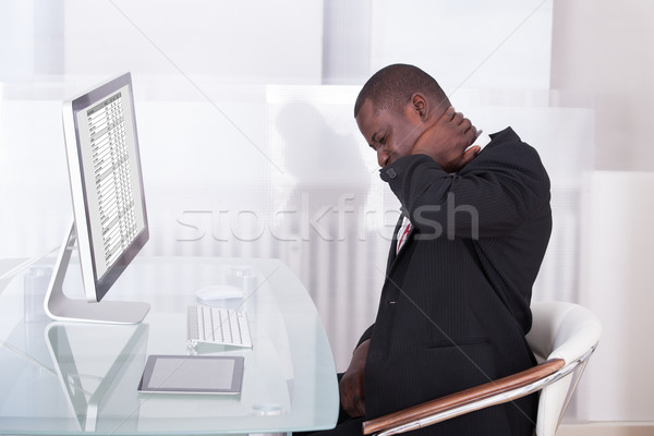 Businessman Suffering From Neck Pain Stock photo © AndreyPopov