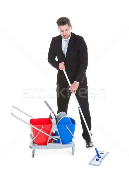 Businessman Mopping Over White Background Stock photo © AndreyPopov