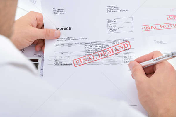 Man Holding Invoice With Final Demand Notification Stock photo © AndreyPopov