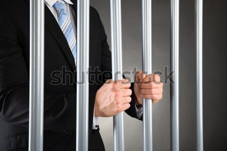 üzletember görbület rácsok börtön közelkép kéz Stock fotó © AndreyPopov