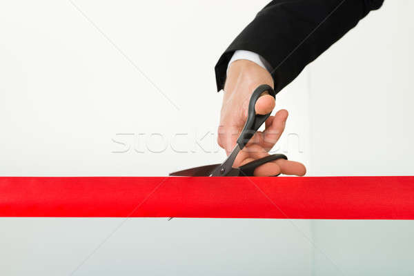 Businessman Cutting Red Ribbon With Scissors Stock photo © AndreyPopov