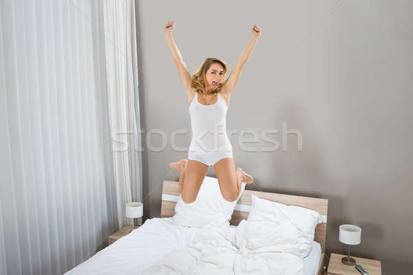 Heyecanlı kadın atlama yatak portre genç kadın Stok fotoğraf © AndreyPopov