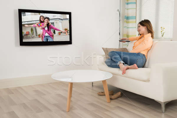 女子 坐在 沙發 看電視 年輕女子 房間 商業照片 © AndreyPopov