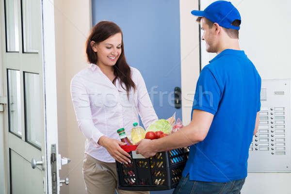 Grocery Delivery Courier At Home Stock photo © AndreyPopov