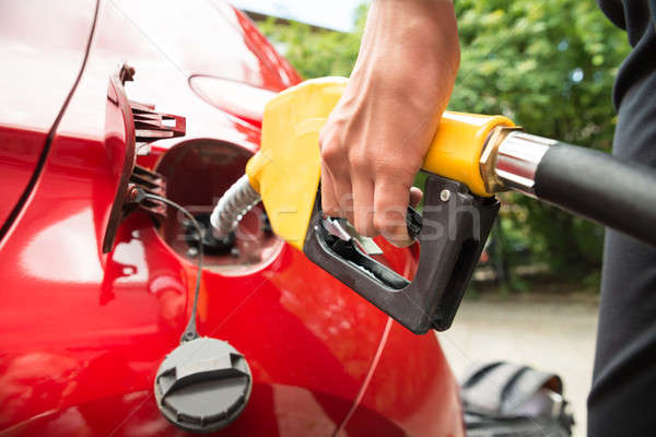 Close-up Of Businesswoman's Hand Refueling Car's Tank Stock photo © AndreyPopov