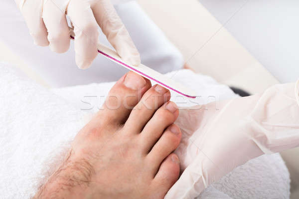 Beautician Hand Filling Person's Nail Stock photo © AndreyPopov