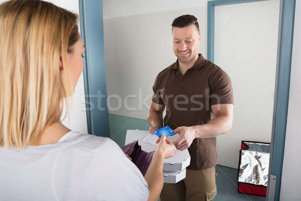 Pizza Delivery Man Accepting Credit Card Stock photo © AndreyPopov