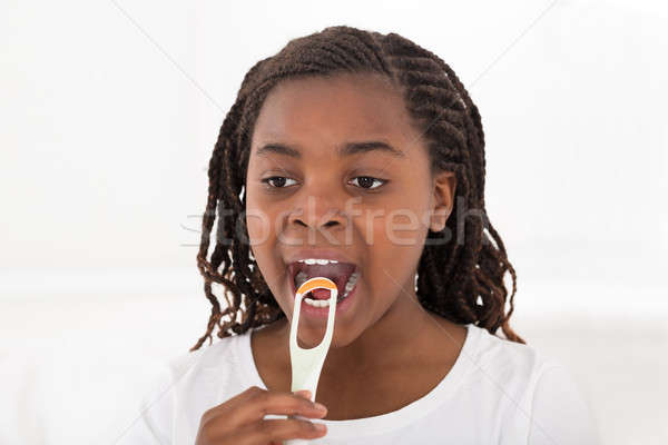 African Girl Cleaning Her Tongue Stock photo © AndreyPopov