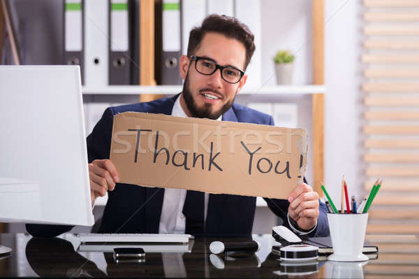 Businessman Holding Cardboard With Thank You Text Stock photo © AndreyPopov