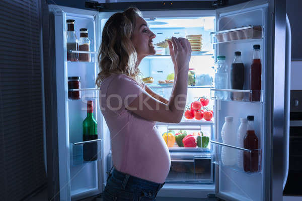 Pregnant Woman Eating Slice Of Cheese Stock photo © AndreyPopov
