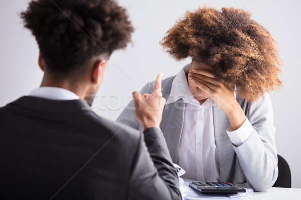 Stock photo: Businessman Pointing At His Female Employee