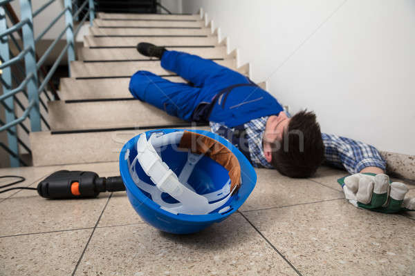 мастер на все руки лестница бессознательный шлема дрель полу Сток-фото © AndreyPopov