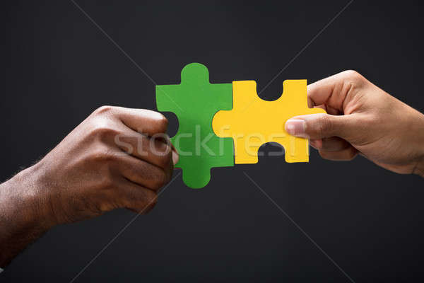 Hands Combining White Puzzle Pieces Stock photo © AndreyPopov