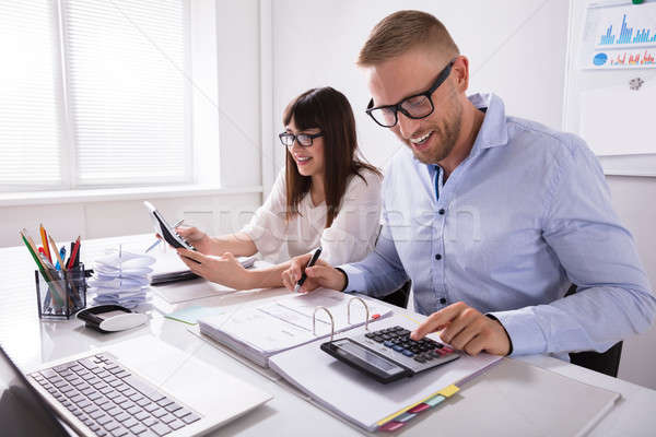 Two Businesspeople Calculating Invoice Stock photo © AndreyPopov