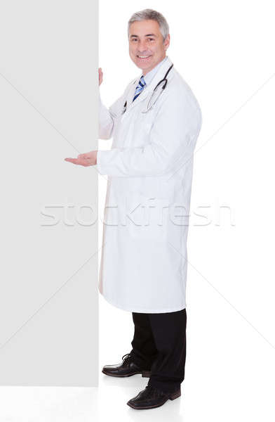 Portrait Of Male Doctor Holding Placard Stock photo © AndreyPopov