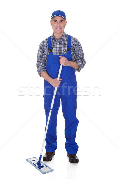 Mature Man Cleaning Floor With Mop Stock photo © AndreyPopov