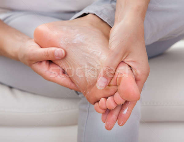 Woman applying cream on feet Stock photo © AndreyPopov